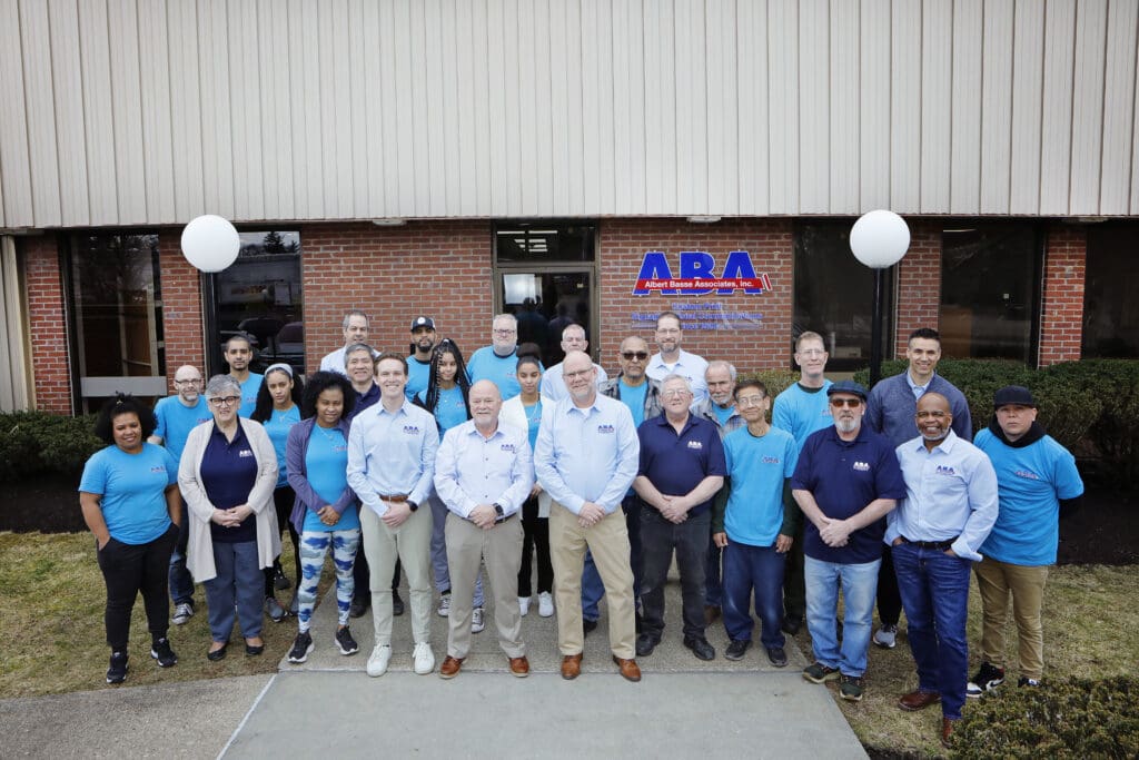 Albert Basse Associates group photograph standing in front our their facility in Stoughton, MA